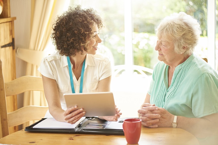 Caregiver helping patient leave a review.